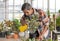 Senior Asian man watering for a small tree for a hobby in home planting corner with happiness and calm