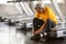 Senior asian sport man tying shoelaces on treadmill in fitness gym ready walking with headphone and water bottle . elder male