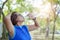 Senior asian woman drinking water bottle after work out exercising