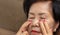 Senior asian woman has eyestrain and fatigue