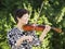 Senior Asian Woman Playing Violin outdoors