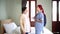 Senior Asian woman talking with Asian woman nurse wearing scrubs in the bedroom. Caregiver visit at home. Home health care.
