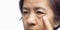 Senior asian woman worry about eye bags and dark spot