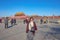 Senior asian women traveler try to make Salute pose and stand on Tiananmen square in front of the Forbidden Palace