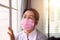 Senior asian women wearing masks protect corona virus or covid-19 at home,SARS cov-2 infection