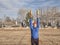 Senior athletic male is exercising with wooden Indian clubs