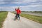 senior athletic man is drinking water during biking a gravel touring bike on a levee trail along Chain of Rocks Canal