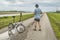 senior athletic man with a folding bike - biking on a levee trail along Chain of Rocks Canal