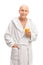 Senior in a bathrobe holding an orange juice