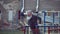 Senior bearded man with strong muscular arms exercising outdoors, doing pull ups, elderly male performing pulling exercise on hori
