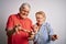 Senior beautiful couple standing together over isolated white background disgusted expression, displeased and fearful doing