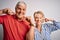 Senior beautiful couple standing together over isolated white background smiling cheerful showing and pointing with fingers teeth