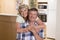 Senior beautiful middle age couple around 70 years old smiling happy together at home kitchen looking sweet in lifetime husband an