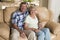 Senior beautiful middle age couple around 70 years old smiling happy together at home living room sofa couch looking sweet in life