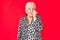 Senior beautiful woman with blue eyes and grey hair wearing casual and modern leopard animal print shirt looking stressed and