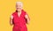 Senior beautiful woman with blue eyes and grey hair wearing a red summer dress success sign doing positive gesture with hand,