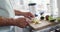 Senior biracial man preparing healthy drink in kitchen