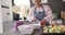 Senior biracial woman cooking dinner and chopping vegetables in kitchen, unaltered, in slow motion