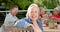 Senior biracial woman enjoys a hearty laugh at an outdoor gathering