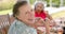 Senior biracial woman enjoys a meal outdoors