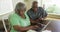 Senior black couple using laptop to do online banking