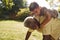 Senior black man with grandson riding on his back