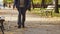 Senior blind man walking with a stick in a park fall horizontal