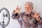 Senior blogger with recording video  with happy and funny face. White-haired and beard, white background