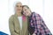 Senior breast cancer patient sitting with her daughter and looking at camera, cancer concept