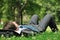 Senior business man lying in grass