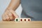 Senior business woman choose green arrow up among down arrows on wood cubes for business growth concept