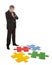 Senior businessman assembling a jigsaw puzzle