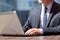 Senior businessman with laptop at outdoor cafe