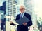 Senior businessman with ring binder folder in city