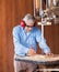 Senior Carpenter Cutting Wood With Bandsaw