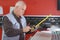 Senior carpenter hands marking measurement on wooden plank