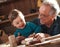 Senior carpenter and his grandson