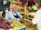 Senior cashier serving customer in greengrocer