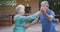 Senior Caucasian couple dancing and smiling in the garden