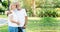 Senior Caucasian couple hugging in park. Family with a happy smile feels relaxed with nature in the morning