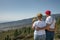 Senior Caucasian couple looking at the green slopes of Guimar Valley, Tenerife, Canary Islands, Spain