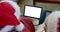 Senior caucasian couple in santa hats with tablet with copy space at christmas, slow motion