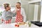 Senior caucasian couple smiling happy giving food to each other at the kitchen