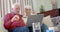 Senior caucasian couple using laptop for online doctor consultation at home, slow motion