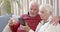 Senior caucasian couple using smartphone for online doctor consultation at home, slow motion