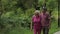 Senior caucasian couple walking in park embracing. Elderly man walks with woman. Husband, wife