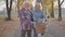 Senior Caucasian family standing in the foggy autumn park with bicycle and talking. Happy retired mature couple spending