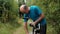 Senior caucasian male in blue t-shirt trying to ride a bicycle.