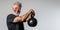 Senior Caucasian man doing exercise with kettlebell