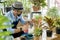 Senior caucasian man or grandfather with a mustache beard enjoys gardening for the tree at home